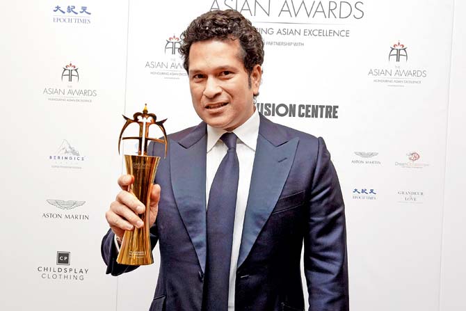 Sachin Tendulkar poses with his Fellowship Award during the Asian Awards in London. PIC/AFP