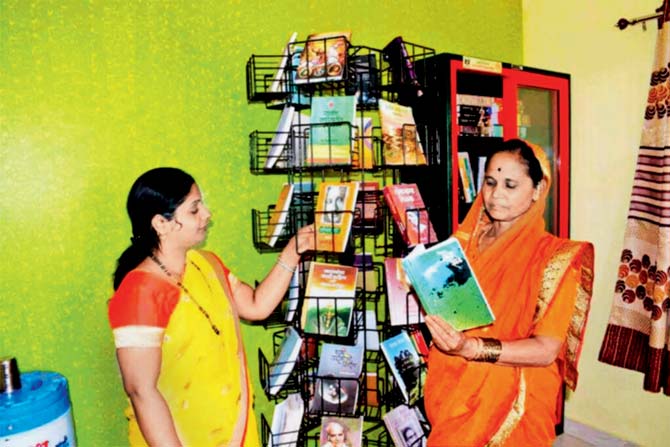 Women skim through books at a reader hotpot. Pic /PTI