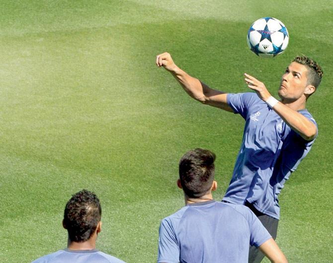 Real Madrid’s Cristiano Ronaldo heads the ball during a training session yesterday ahead of their Champions League semi-final second leg clash against Atletico Madrid tonight. Real won the first leg 3-0 last week thanks to a hat-trick by their Portuguese striker. Pic/PTI