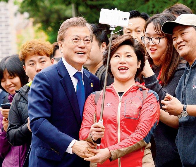 Presidential candidate Moon Jae-in with a supporter after voting. Pic/AP