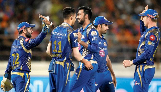 Mumbai Indians cricketer Krunal Pandya (centre) celebrates the wicket of Gujarat Lions’ all-rounder Irfan Pathan with teammates during the Indian Premier League game at the Saurashtra Cricket Association Stadium in Rajkot on April 29. Pic/AFP