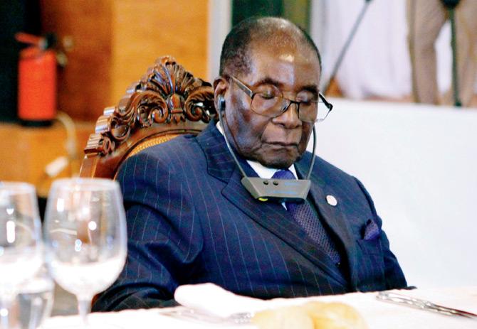 File photo shows Robert Mugabe attending a State Dinner for the Africa-France Summit; his eyes are closed, apparently to avoid  bright lights. Pic/AFP