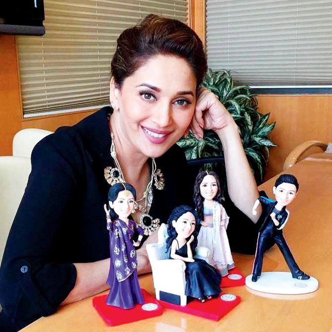 The 3D figurines; with a special card; fans presenting Madhuri with a tiara. 