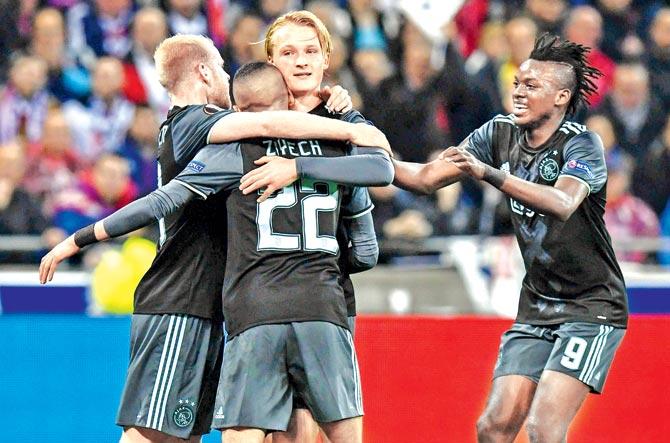 Ajax players celebrate a goal against Lyon during the Europa League semi-final second leg in France on Thursday. Pic/AFP