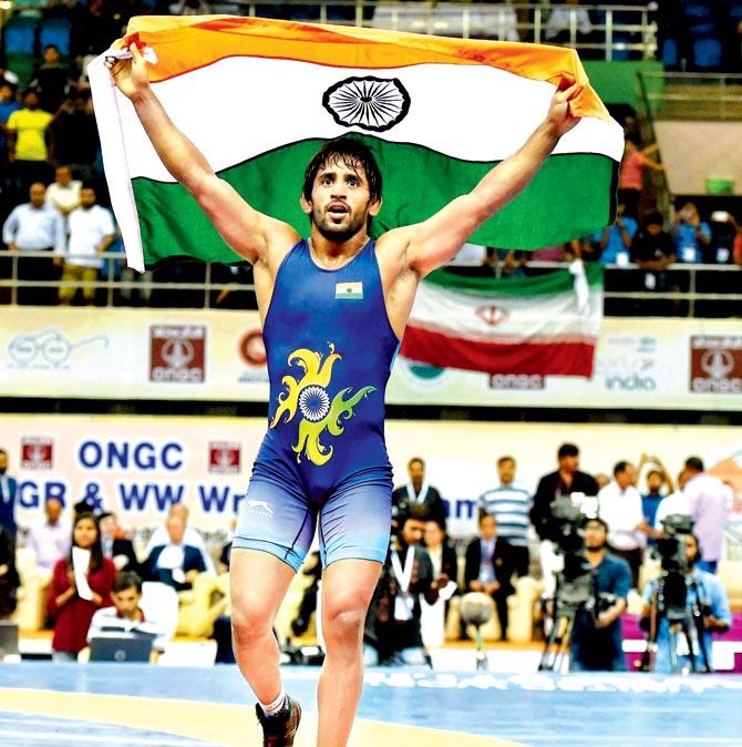 Indian wrestler Bajrang Punia celebrates after winning gold at the Asian Wrestling Championship in New Delhi on Saturday. Pics/PTI