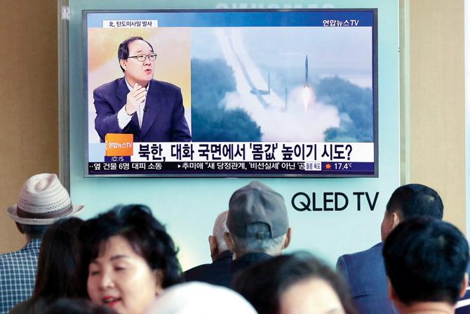 People watch a news programme, showing file footage of a North Korean missile launch, at a railway station in Seoul on Sunday. Pic/AFP