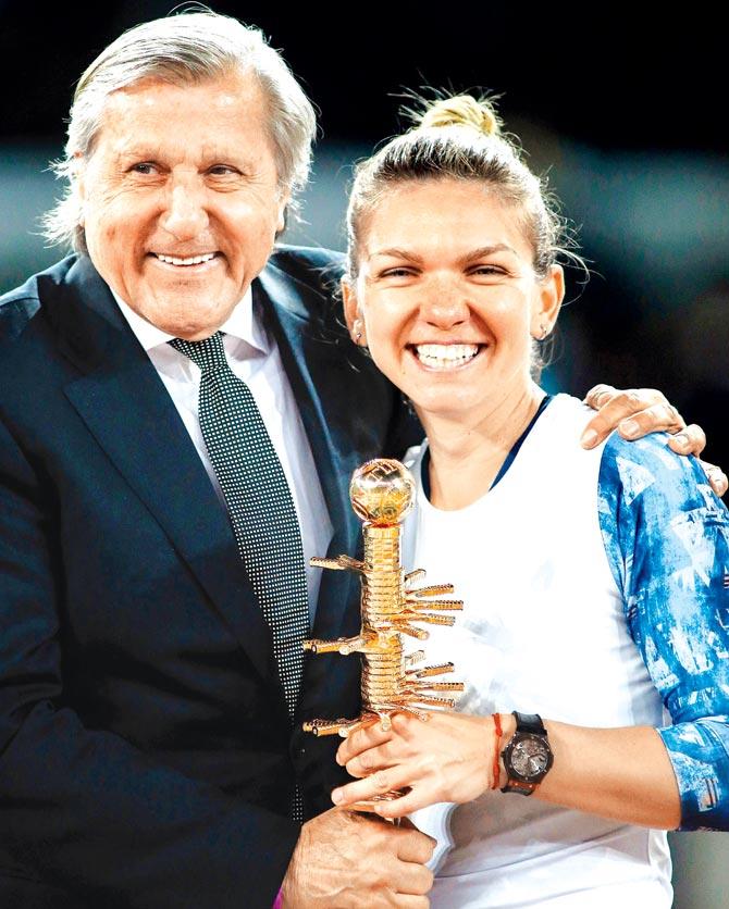 Ilie Nastase (left) with Madrid Open singles winner Simona Halep on Saturday. Pic/AFP