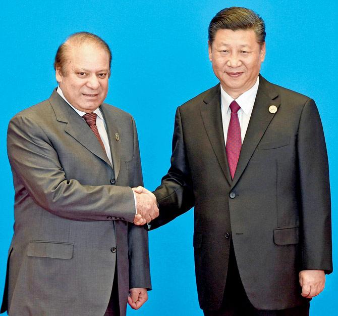 Pakistan Prime Minister Nawaz Sharif (L) shakes hands with China’s President Xi Jinping during the welcome ceremony for the Belt and Road Forum. Pic/AFP