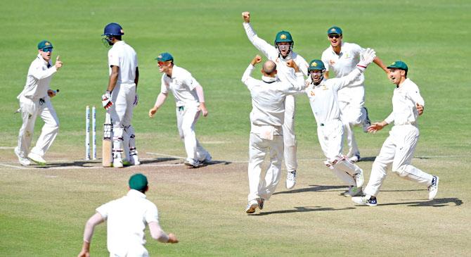 Australian cricketers celebrate after winning the first Test against India in Pune on Saturday. Pic/AFP