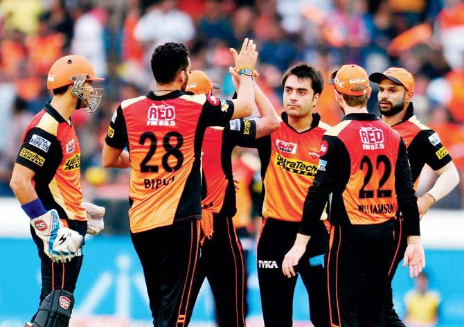 Sunrisers Hyderabad players celebrate the fall of a Rising Pune Supergiant