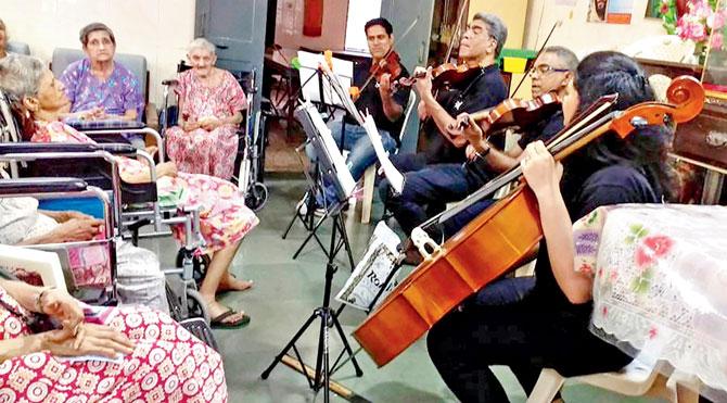 Musicians with the Symphony Orchestra of India play in an old-age home