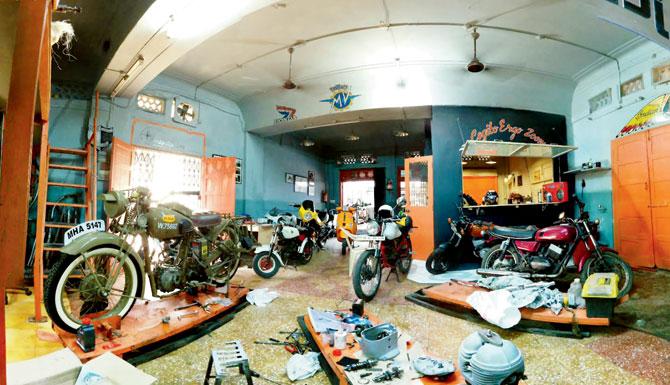 The interior of Garage 52 with different brands of motorcycles and scooters