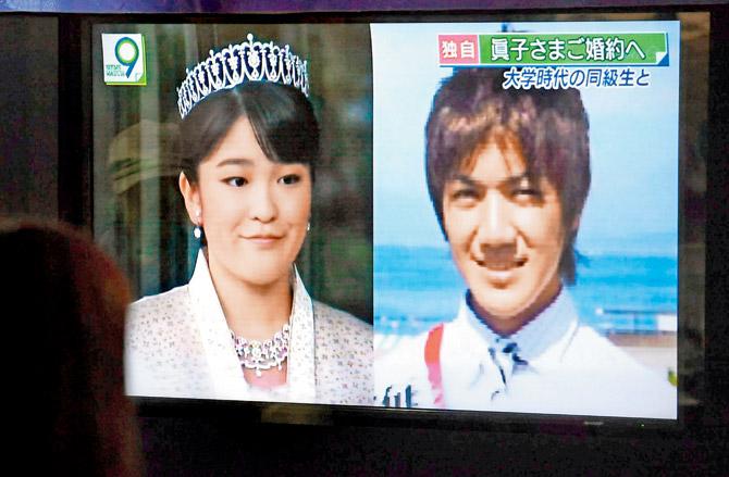 Passers-by watch a news report that Princess Mako, granddaughter of Japan’s emperor, is getting married to Kei Komuro, in Tokyo. Pic/AP