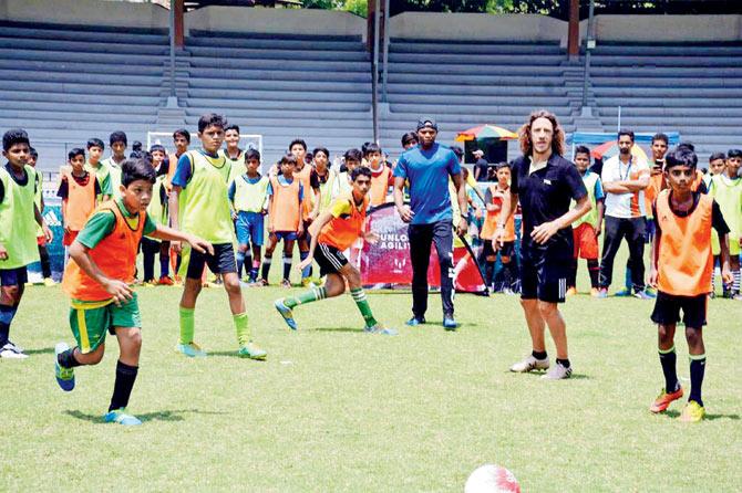 Former Barcelona and Spain defender Carles Puyol plays with kids at the Mumbai Football Arena in Andheri yesterday. Pic/PTI