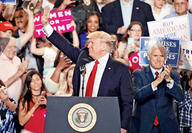 President Donald Trump (L) acknowledges supporters as Vice President Mike Pence (R) backs him up at the rally. Pics/AFP