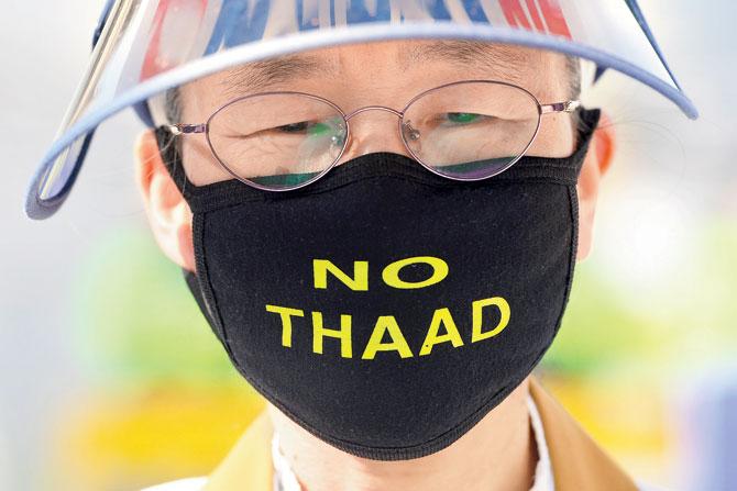 A South Korean protester wears a face mask during a rally. Pic/AFP