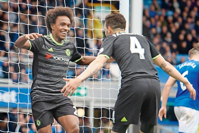 Chelsea’s Willian (left) celebrates his goal with teammate Cesc Fabregas during their EPL match against Everton yesterday. Pic/AFP