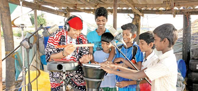 Jamming with kids at a beach. To the far left is the Aludu from Denmark, an aluminium-made drum