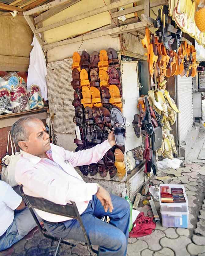 Owner Jalandhar Pawar shows us the range of Kolhapuri chappals for mean at his Dadar store