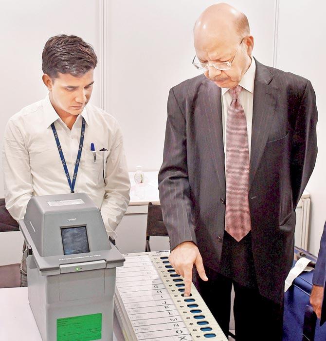 CEC Nasim Zaidi demonstrates the functioning of the EVMs and VVPATs in New Delhi on Saturday. Pic/PTI