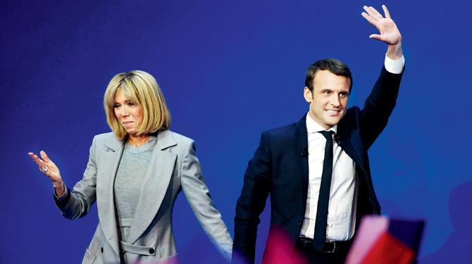 Emmanuel Macron (right) and wife Brigitte Trogneux acknowledge the audience at an event in Paris in April. Pic/AFP