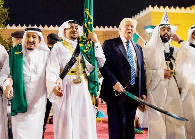DonaAbdulaziz al-Saud (left) dancing with swords. Pic/AFP