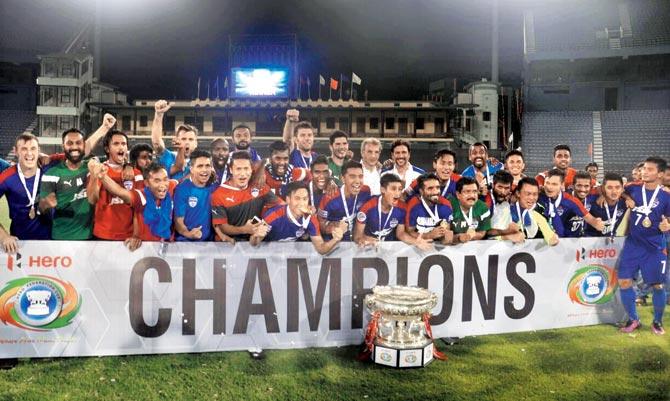 Bengaluru FC players pose with the Federation Cup after defeating Mohun Bagan at the Barabati Stadium in Cuttack