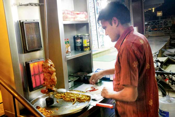 A staffer prepares Chicken Shawarma