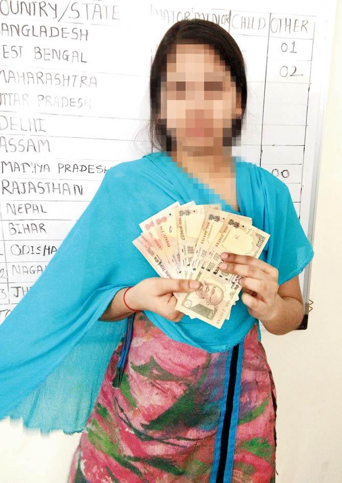 The survivor holds up her old currency notes worth Rs 10,000