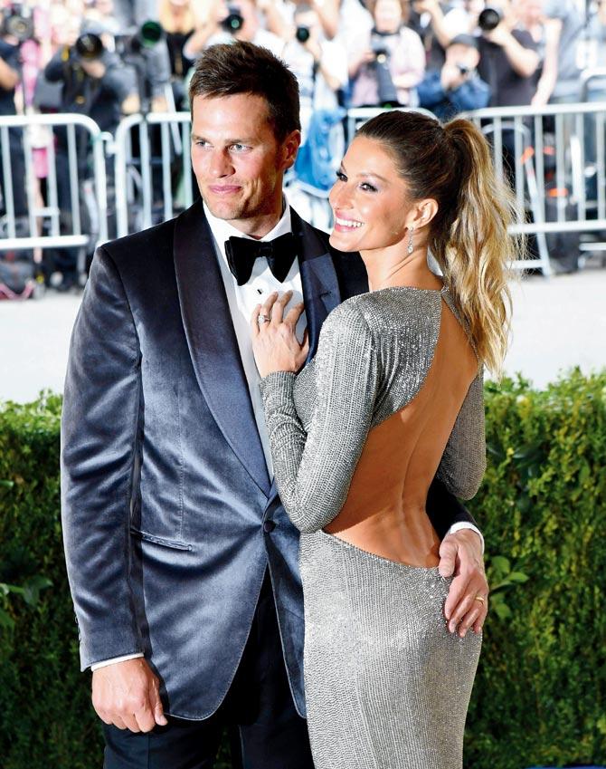 National Football League ace Tom Brady made sure he colour-coordinated with wife Gisele Bundchen. Brady opted for a dark grey satin tuxedo as Bundchen looked stunning in a sexy, slinky silver gown with cut out panels on either side. Pic/AFP