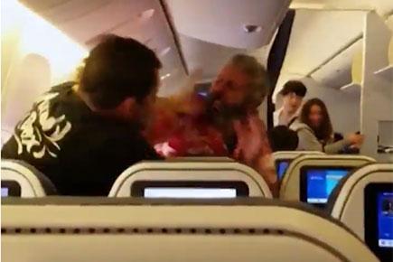 Fight on flight: Two passengers beat each other wildly as video goes viral