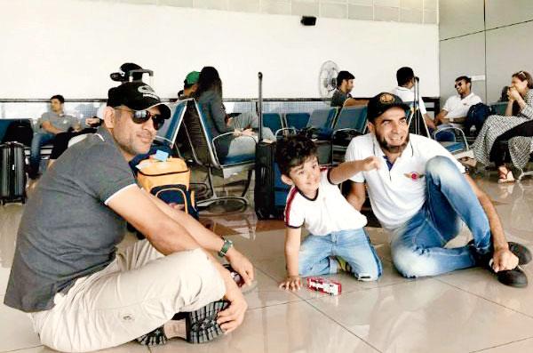 Former India skipper MS Dhoni with RPS teammate Imran Tahir and his son at the airport. Pic/Twitter