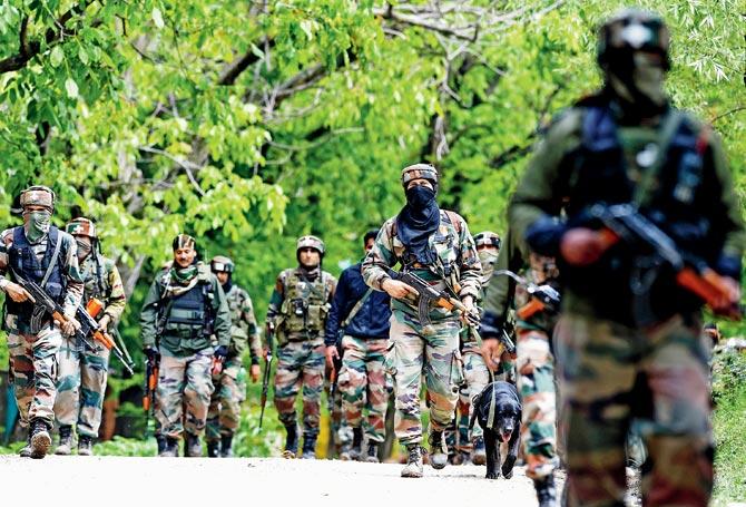 Indian army soldiers patrol during an operation against suspected militants in Turkwangam Lassipora in Shopian south of Srinagar on Thursday. Pic/AFP