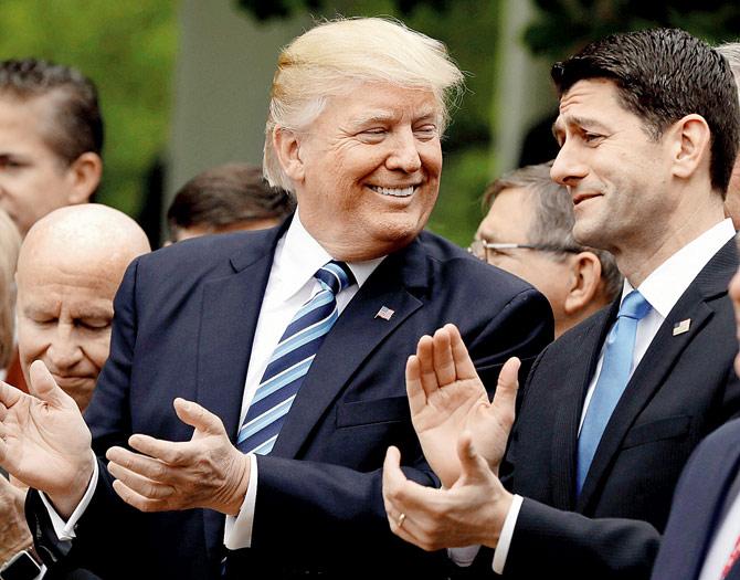 Donald Trump talks to Paul Ryan in the Rose Garden. Pic/AP
