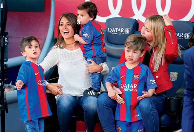 Messi’s partner Antonella Rocuzzo (in white) and  Suarez’s wife, Sofi Balbi with kids. Pic/Getty Images