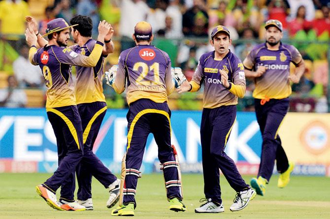 Kolkata Knight Riders skipper Gautam Gambhir (second from right) celebrates the dismissal of Royal Challengers Bangalore’s Virat Kohli with teammates during their match in Bangalore on Sunday. PIC/AFP