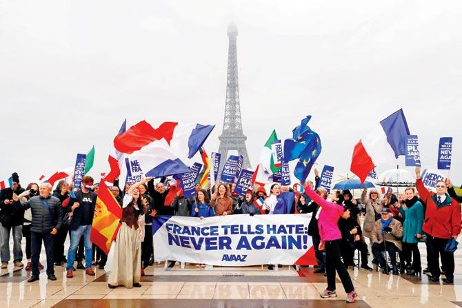 French and European citizens wave flags and Europe’s flags to celebrate the defeat of the Front National outside Eiffel Tower. Pics/AFP