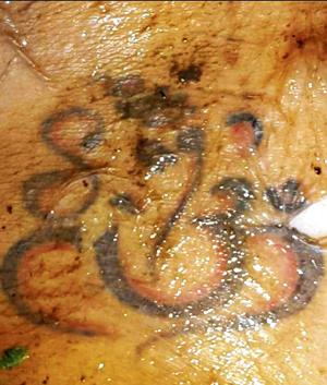 The only clue - a Ganesh and Om tattoo