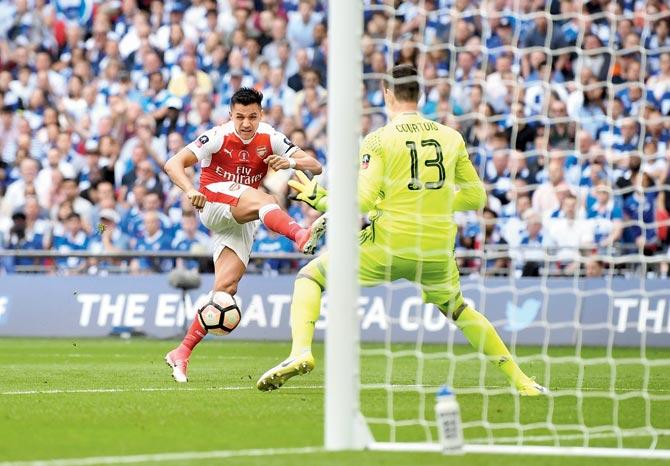 Alexis Sanchez scored his 30th goal of the season past Chelsea goalkeeper Thibaut Courtois to give Arsenal an early fifth-minute lead in the FA Cup final at Wembley Stadium in London on Saturday. The Gunners led 1-0 at half-time. Pic/Getty Images