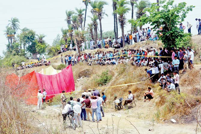 Police investigate the spot at Daurala where the bodies were found. Pic/PTI