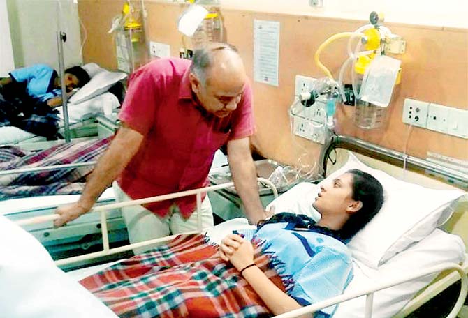 Delhi Deputy CM Manish Sisodia talks to a student who was hospitalised