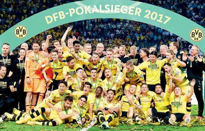 Dortmund players celebrate with the trophy after winning the German Cup final vs Eintracht in Berlin on Saturday. Pic/AFP