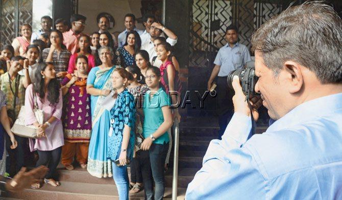 Dr Suhas Pednekar, (in blue shirt) principal of the Ramnarain Ruia College joins the press in taking celebratory photos of HSC students from his college. Pic/Bipin Kokate