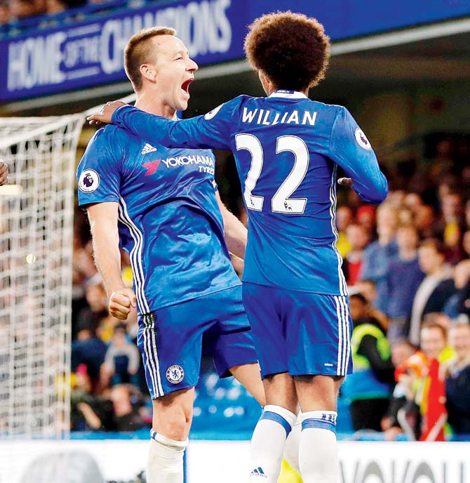 Chelsea skipper John Terry (left) celebrates his goal against Watford with teammate Willian in an EPL match in London on Monday. Pic/AFP