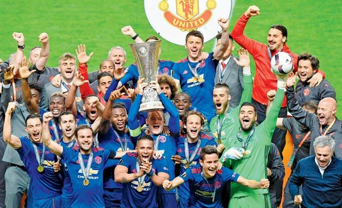 Man United players and boss Jose (extreme right) are jubilant after winning the Europa League final against Ajax on Wednesday. Pic/AFP
