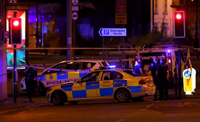 Police deploy at scene of explosion in Manchester, England. Pic/AFP