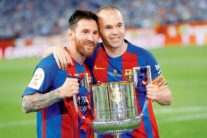 Barca’s Messi and skipper Iniesta pose with the Copa del Rey title after their side defeated Alaves at Madrid on Saturday. Pic/AFP