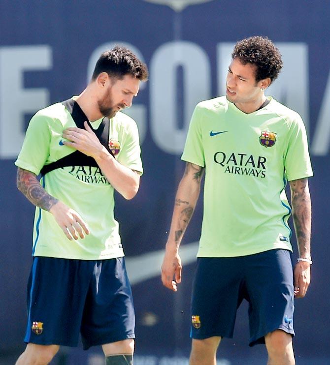 Barca’s Messi (left) chats with teammate Neymar in Barcelona yesterday. Pic/AFP