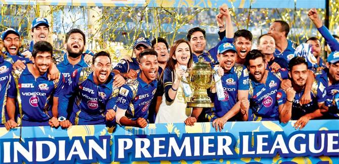 Mumbai Indians players and the team owner Nita Ambani with the IPL 10 trophy, after they won the Indian Premier League final match against Rising Pune Supergiants in Hyderabad on Sunday. Pic/PTI