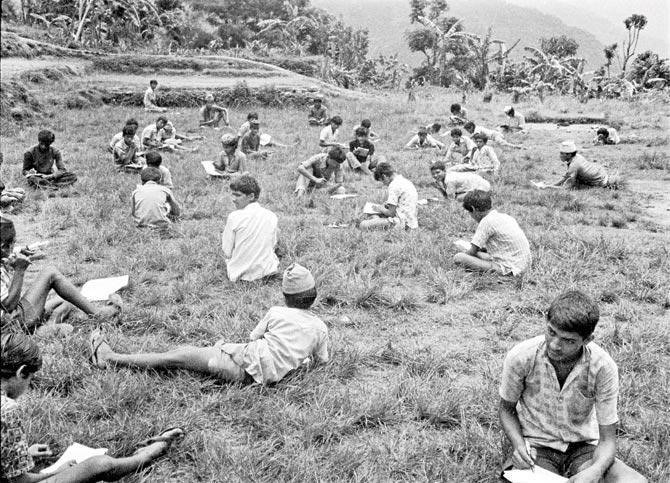 Nepal Picture Library; Students writing their exams in the school’s playground in Chiti Tilahar, Lamjung, 35 mm film, 1975